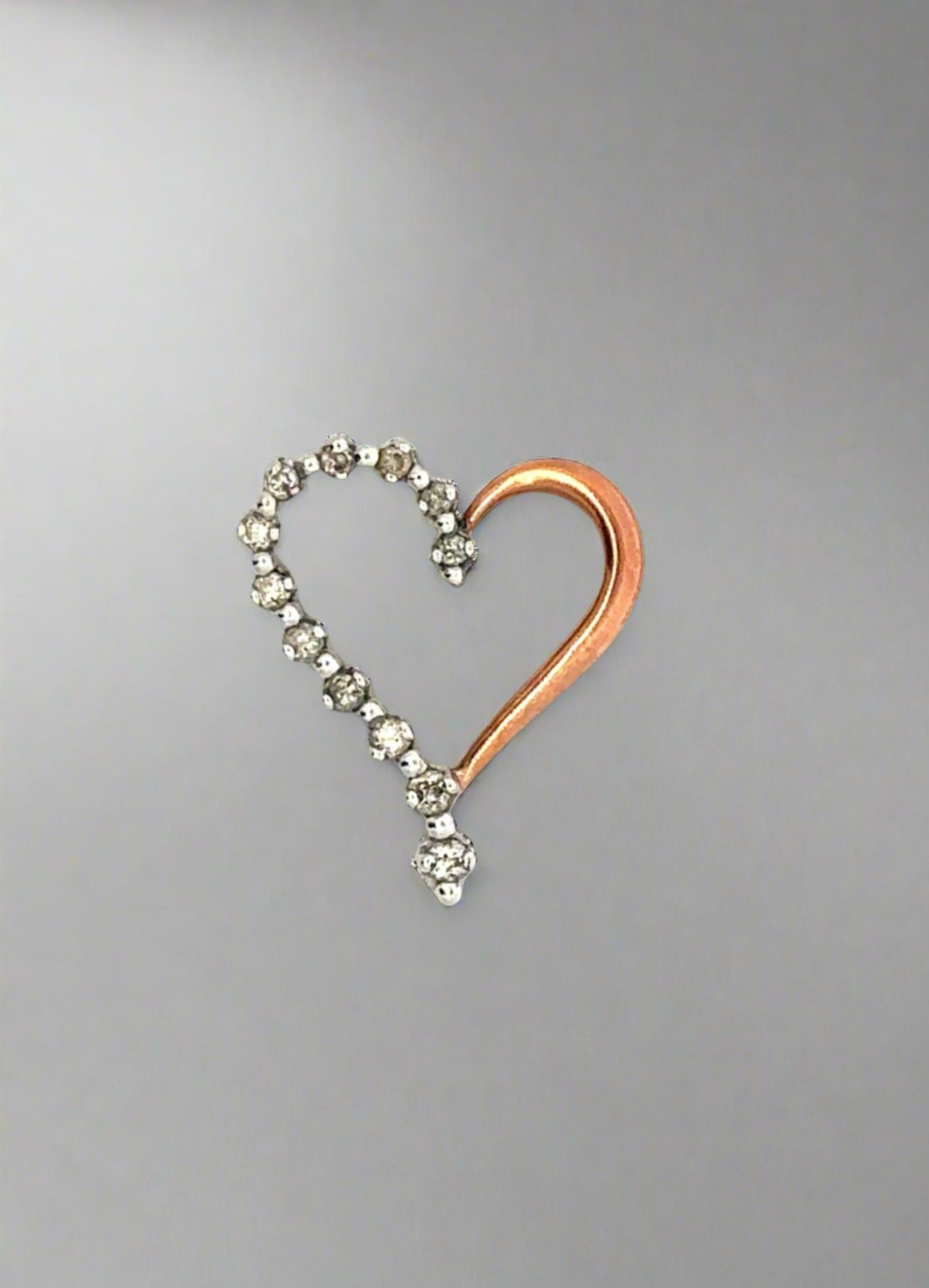 Rose and white gold diamond heart pendant with 12 small round diamonds on half the pendant. Open in the middle