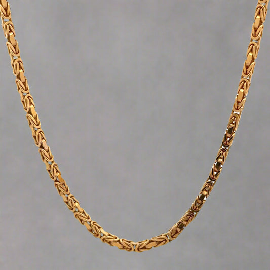 Hanging yellow gold byzantine chain