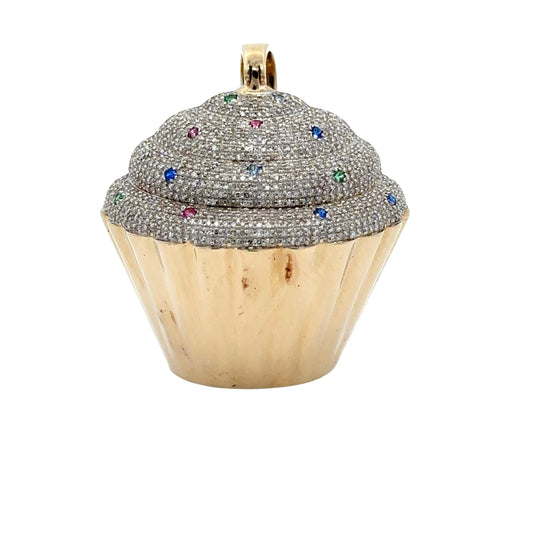 Standing yellow gold cupcake pendant with small round diamonds + green, pink, light blue, + dark blue stones. Discoloration on parts of the gold.