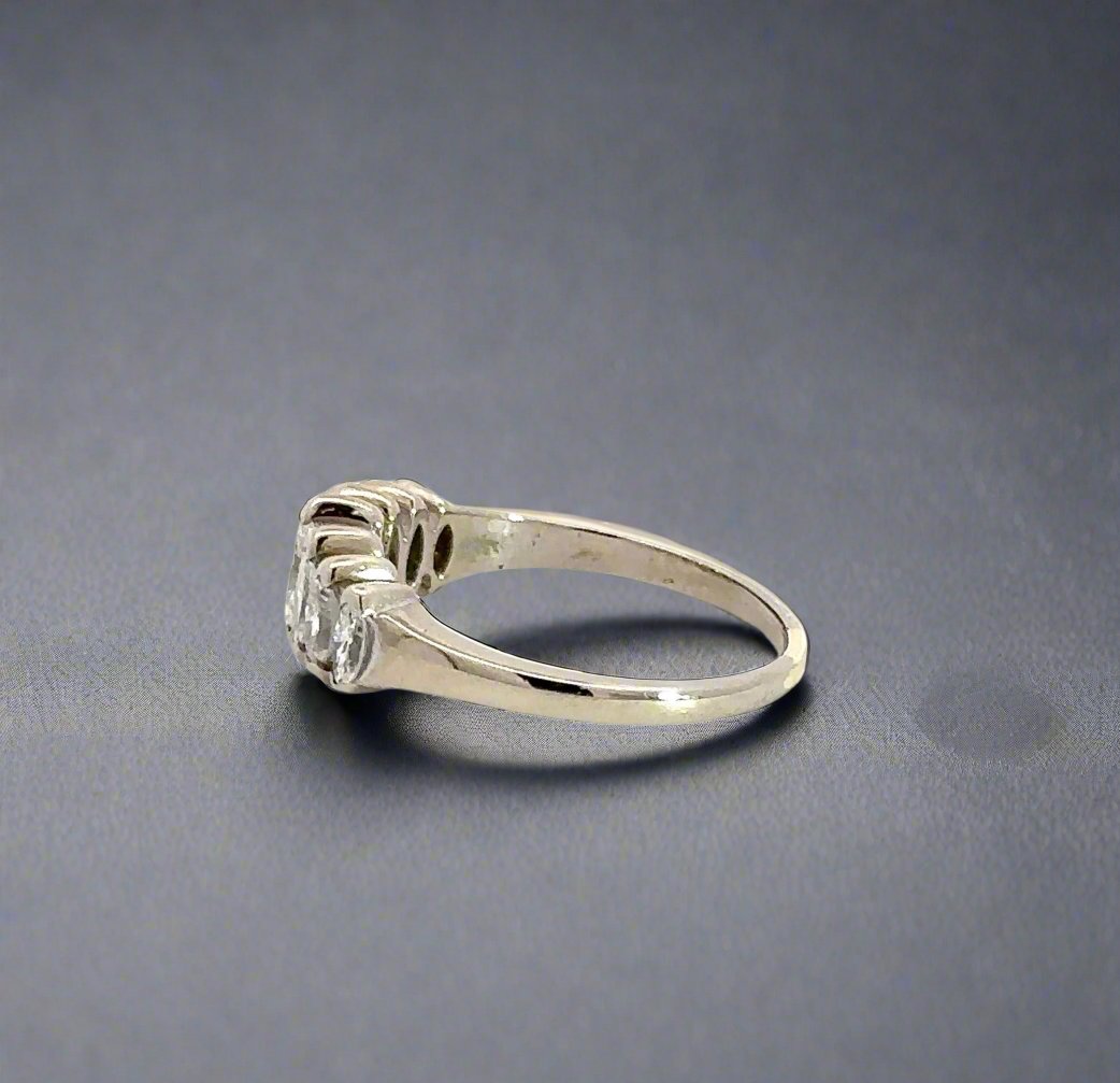 side of white gold diamond ring with some scratches on gold