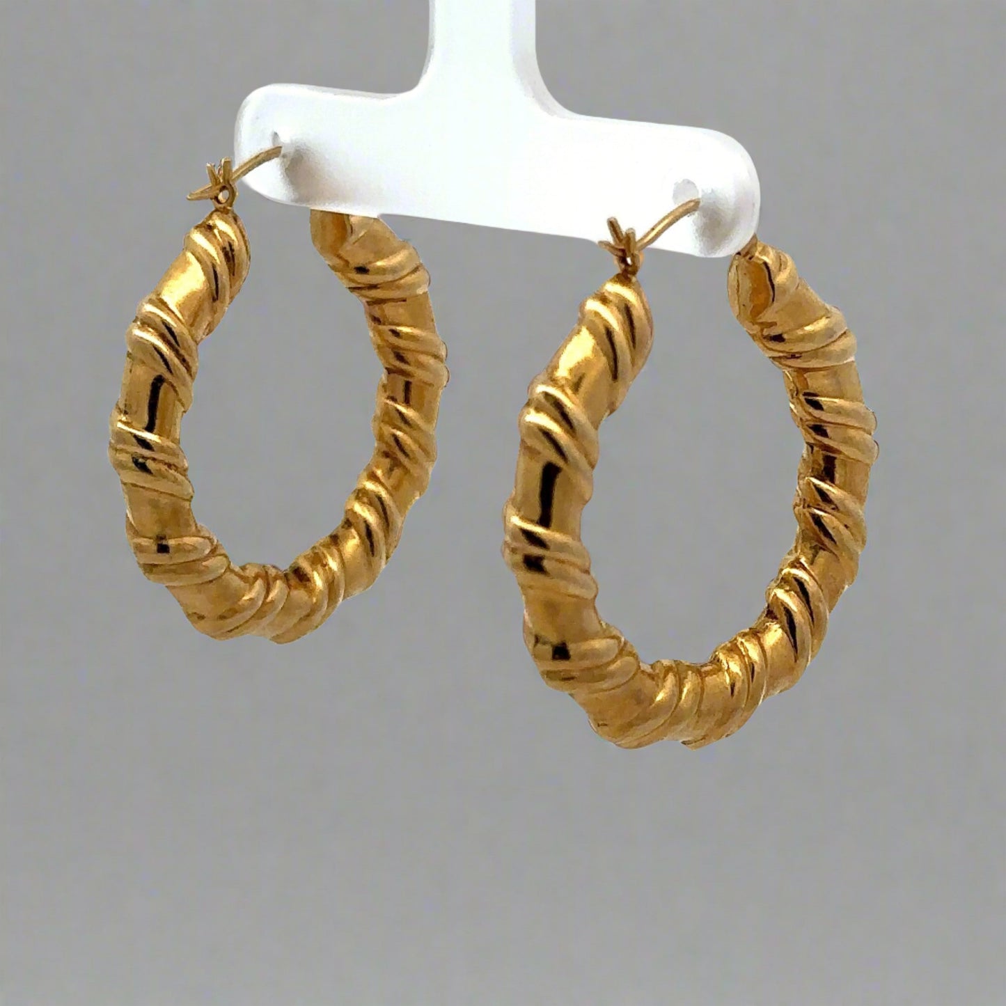 diagonal view of yellow gold hoops