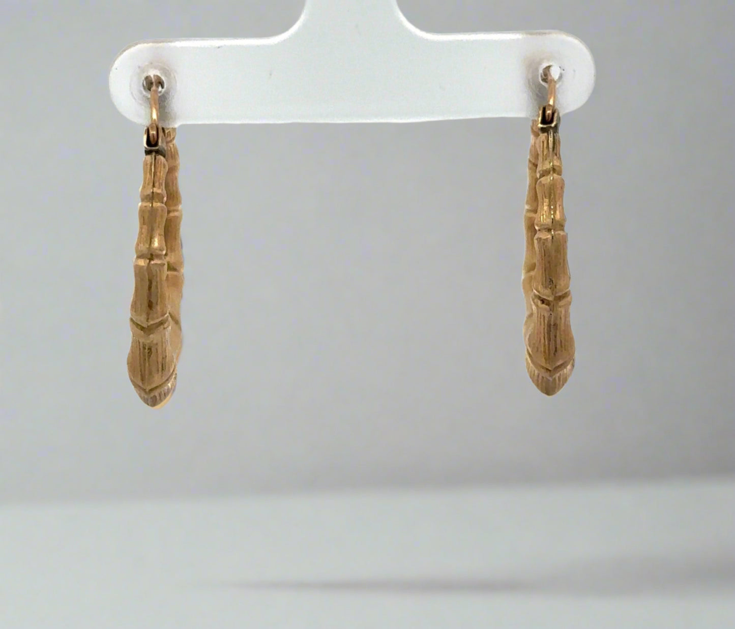 Front of yellow gold bamboo hoop earrings