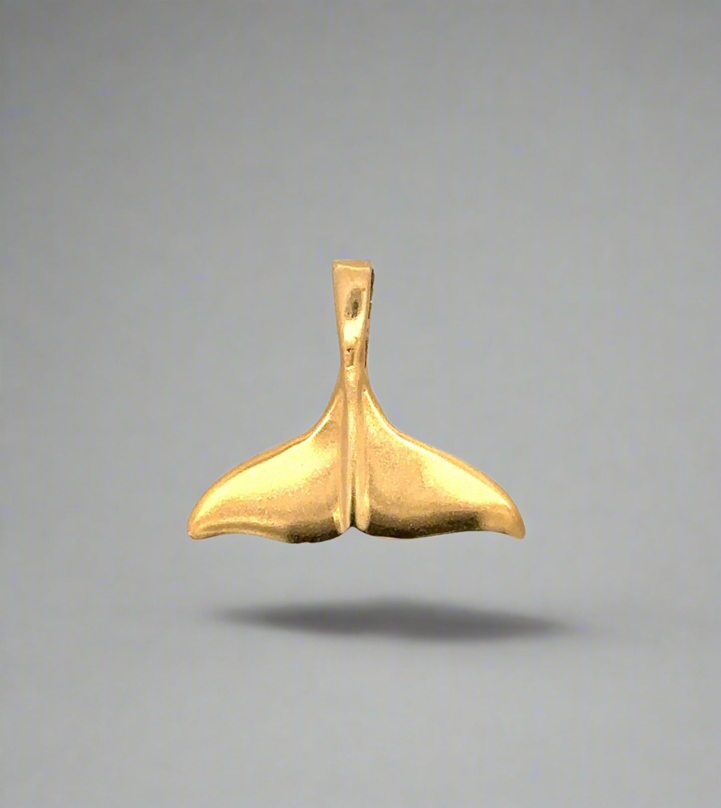 yellow gold whale tail pendant with scratches