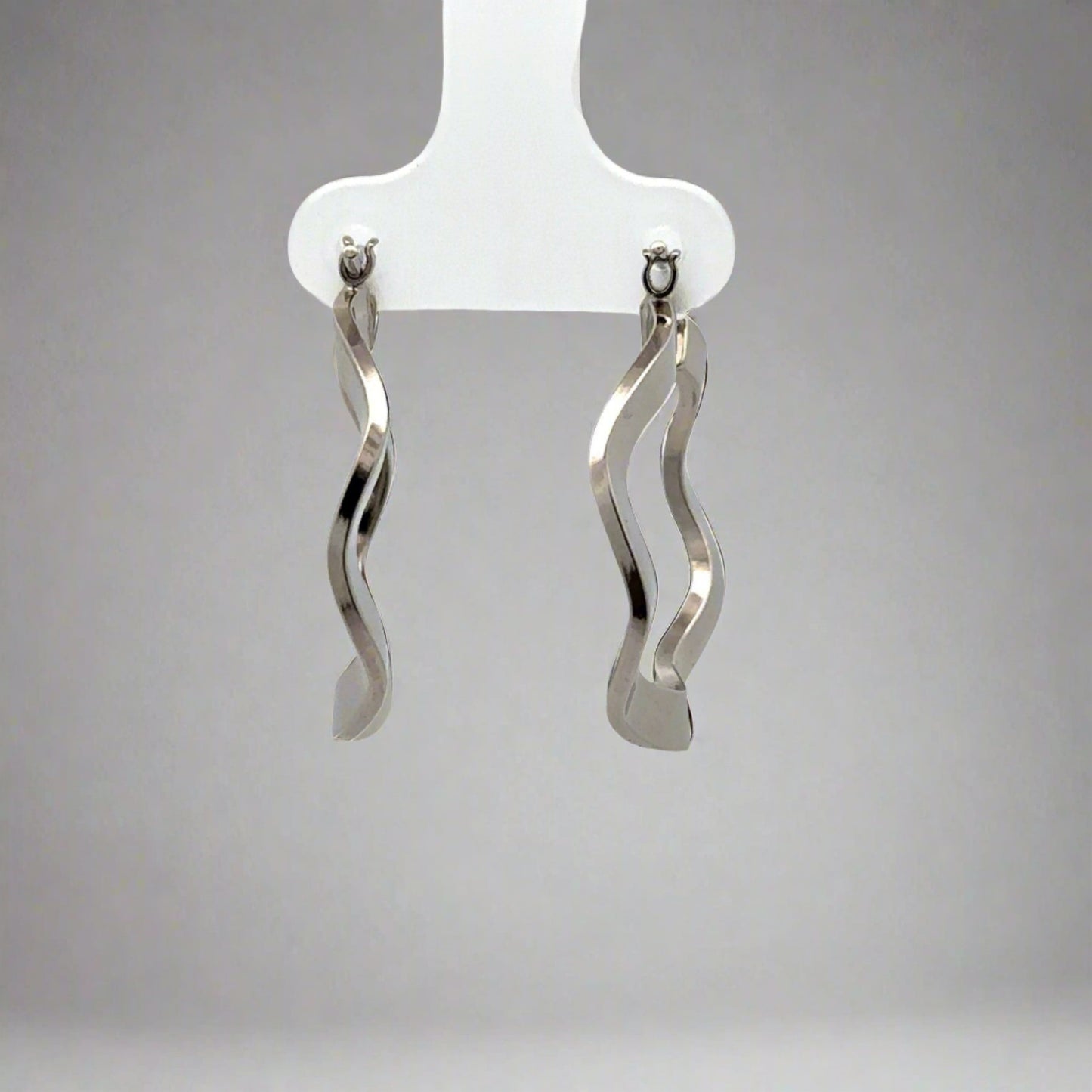 front view white gold wavy hoops