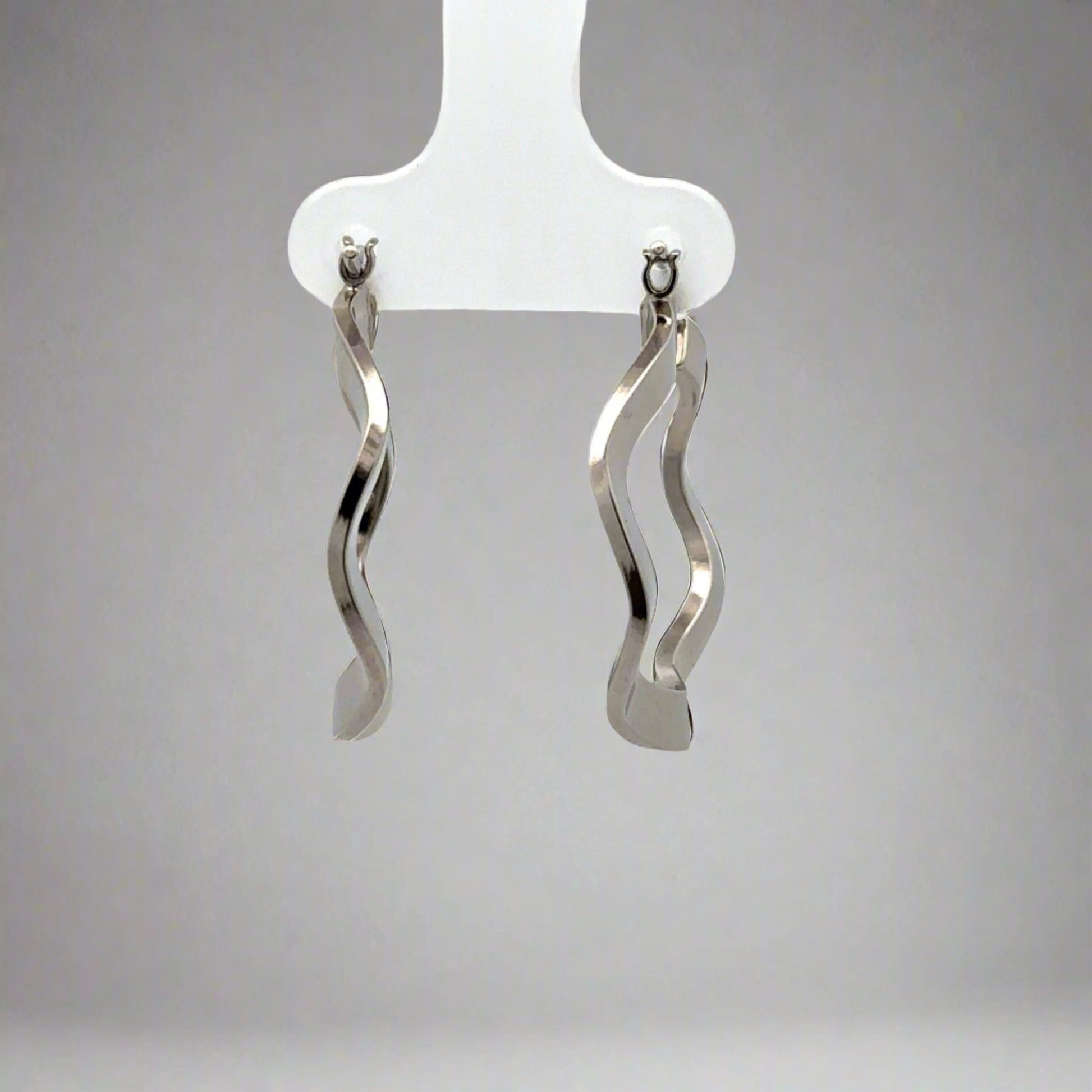 front view white gold wavy hoops