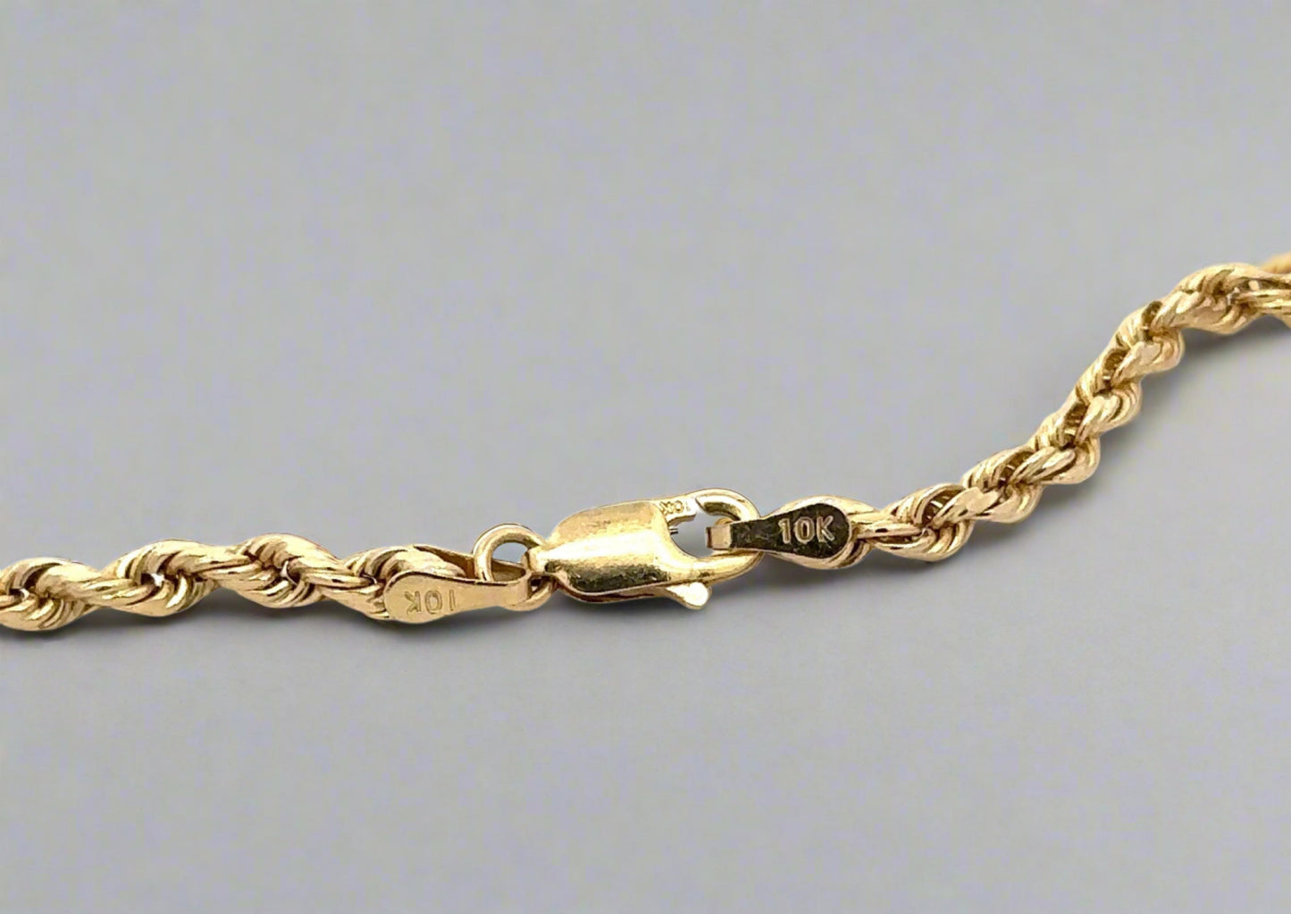 10K yellow gold lobster clasp with stamp and scratches on clasp