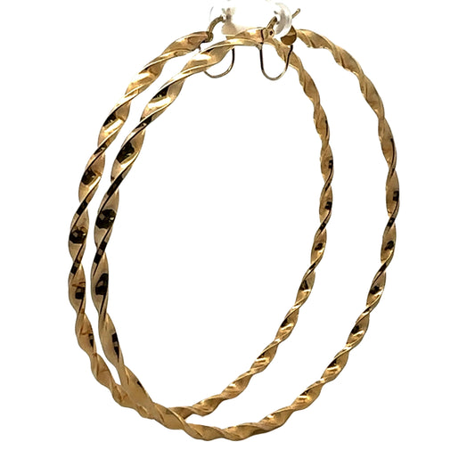 Diagonal view of yellow gold twist hoops in extra large