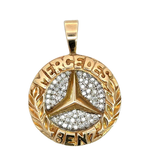 Yellow gold round mercedes benz pendant with mercedes on top and benz on bottom. The logo is in the center with diamonds aroun dit.