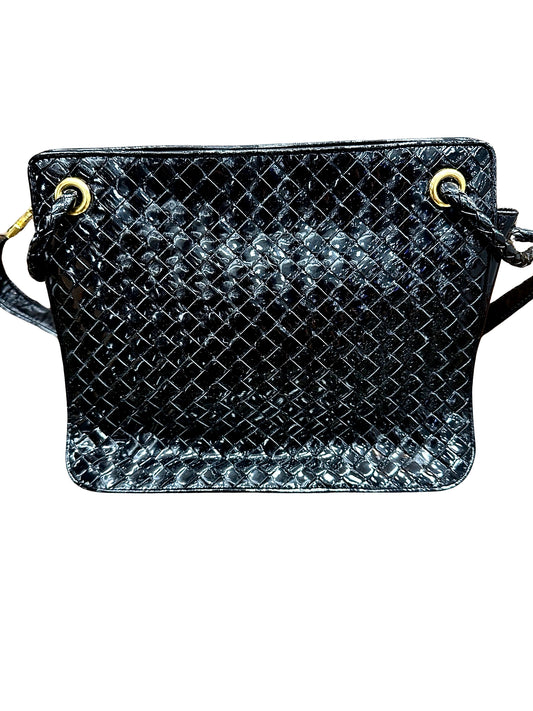 Front of black patent leather bag with woven texture