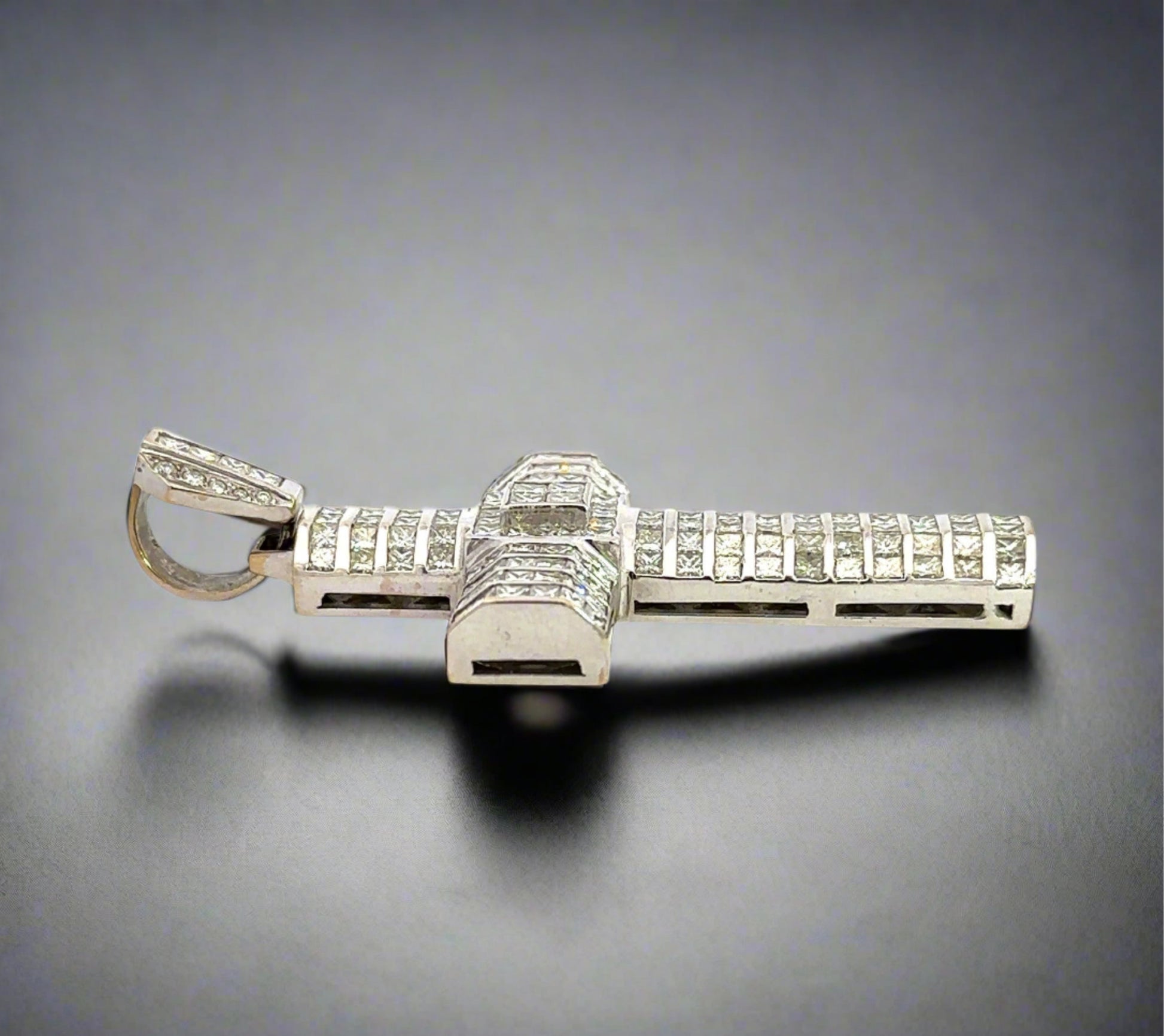 Side of white gold cross pendant with marks on the gold