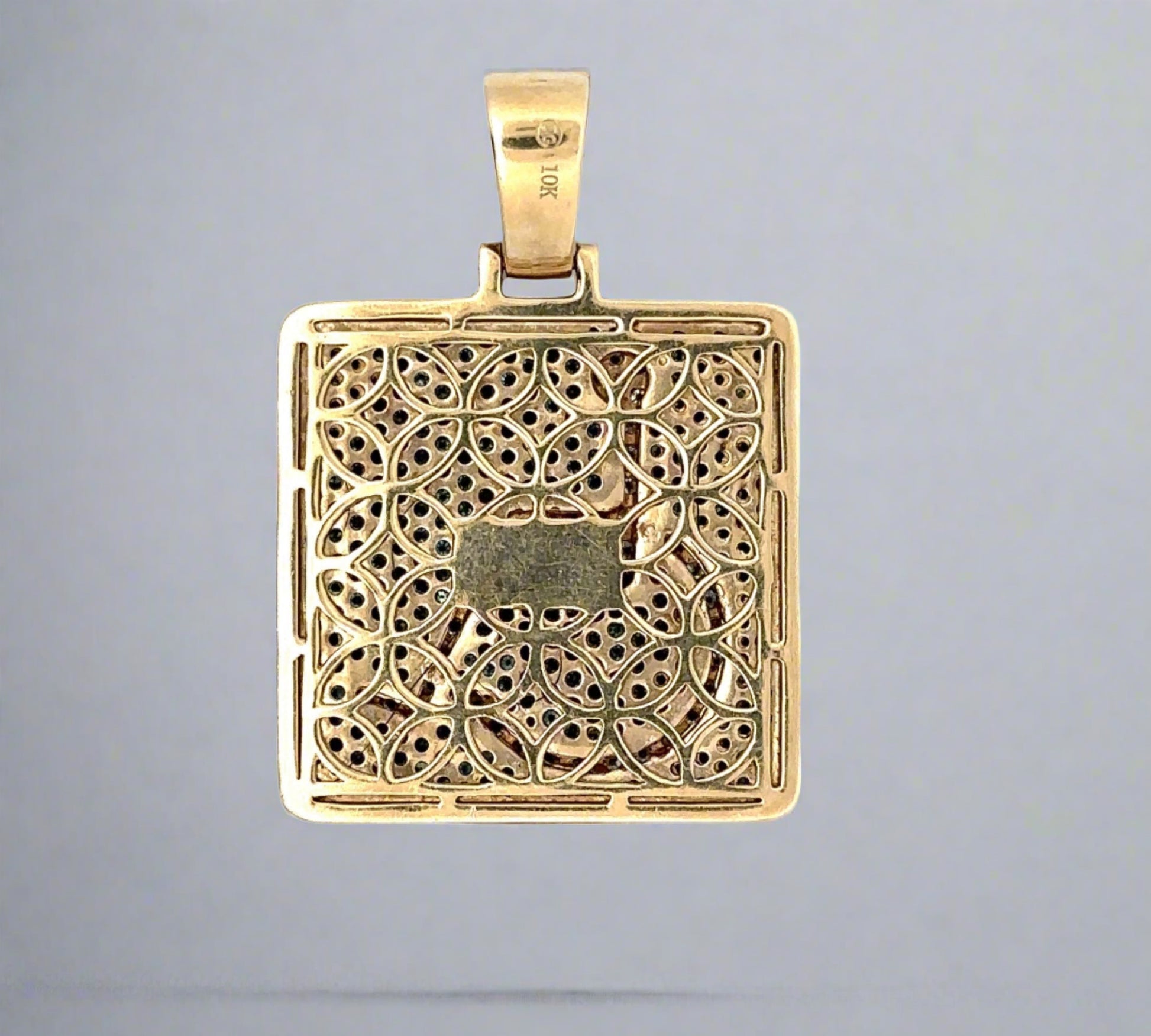 Back of pendant in yellow gold and scratches on the gold. 10K stamp on the bail.