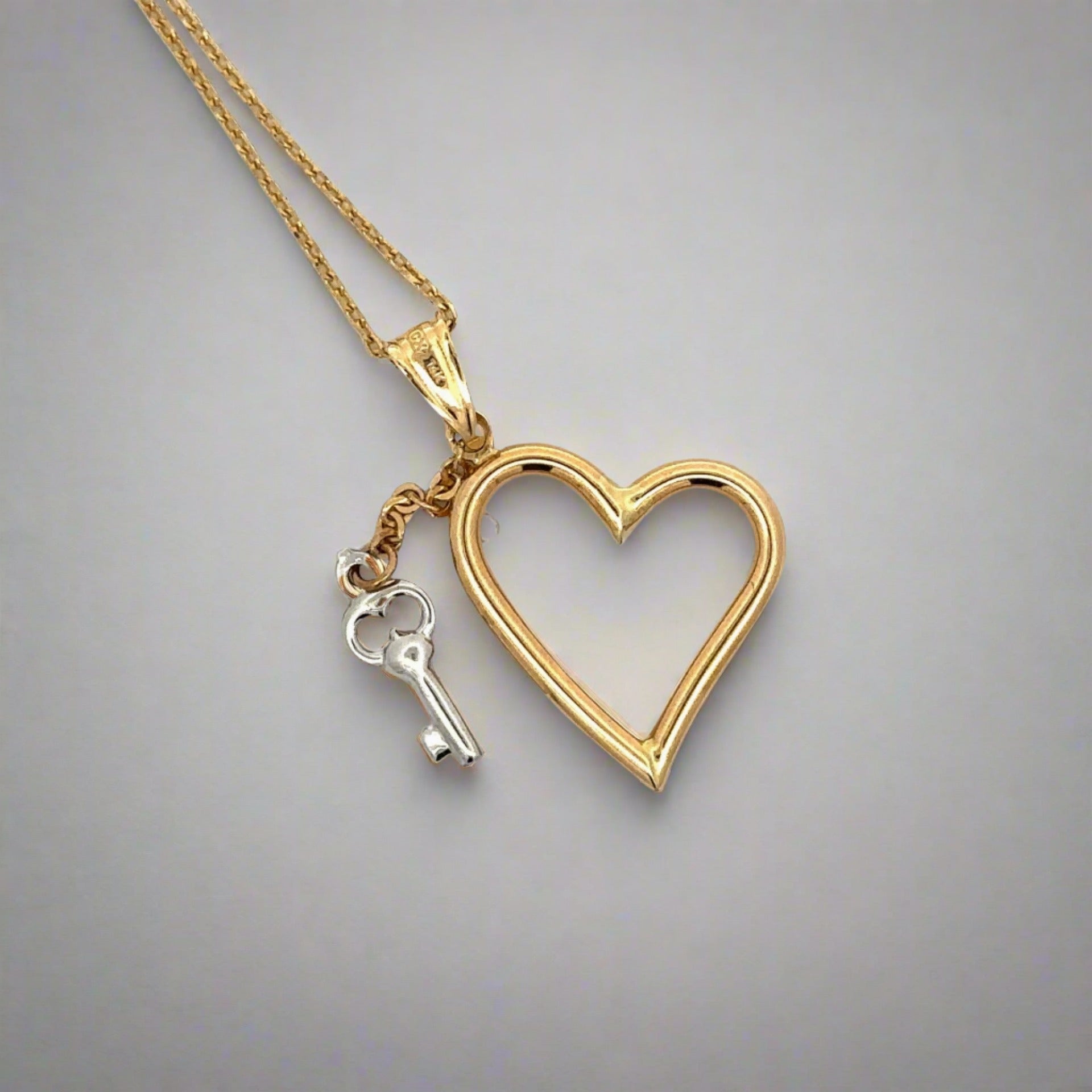 Back of heart + key necklace. Shows some scratches on bail