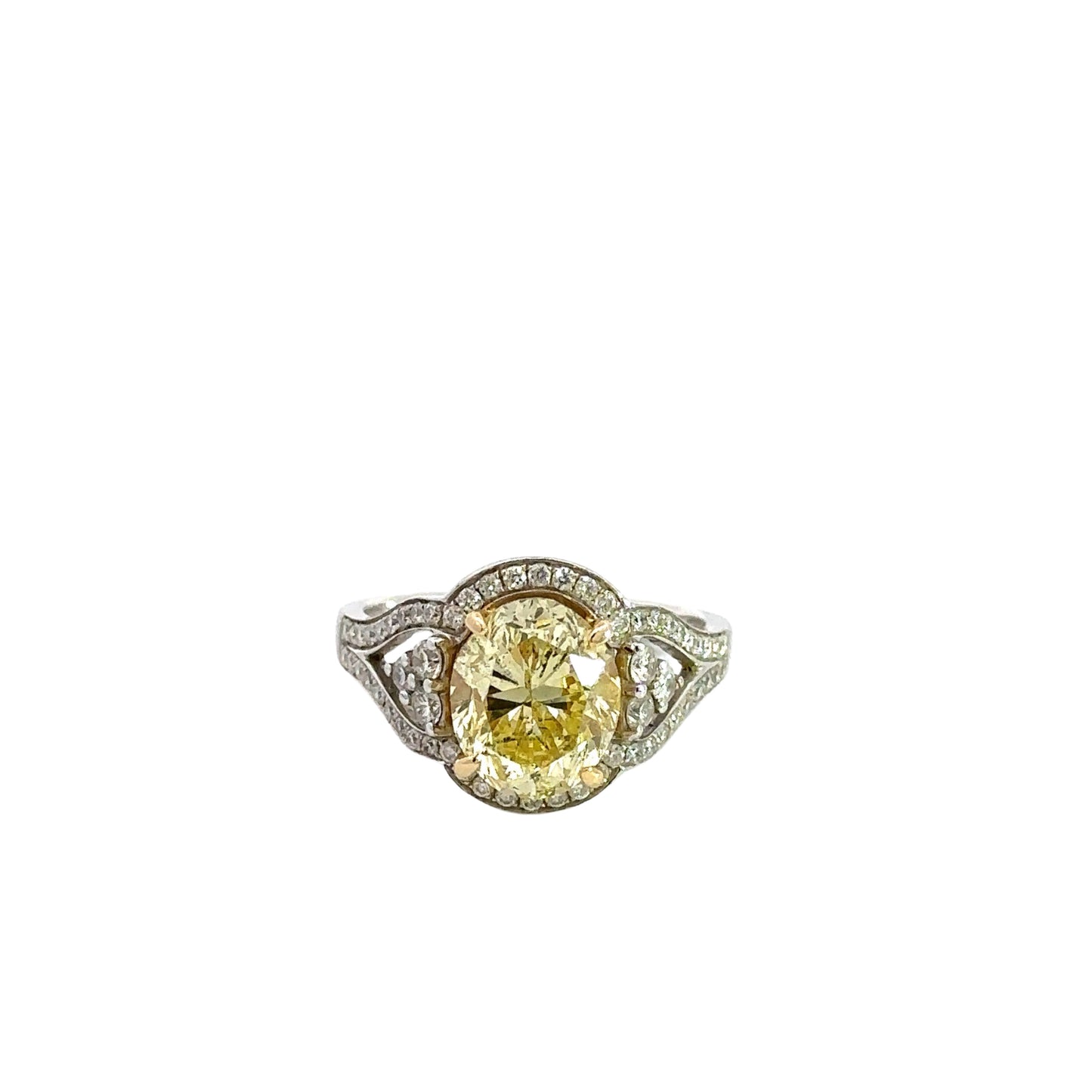White gold ring with yellow oval diamond in center and small round diamonds around it