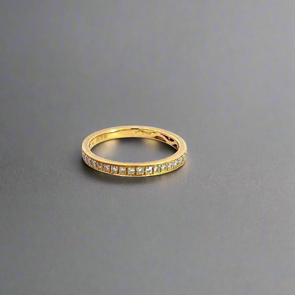 Front of yellow gold ring with small round diamonds.
