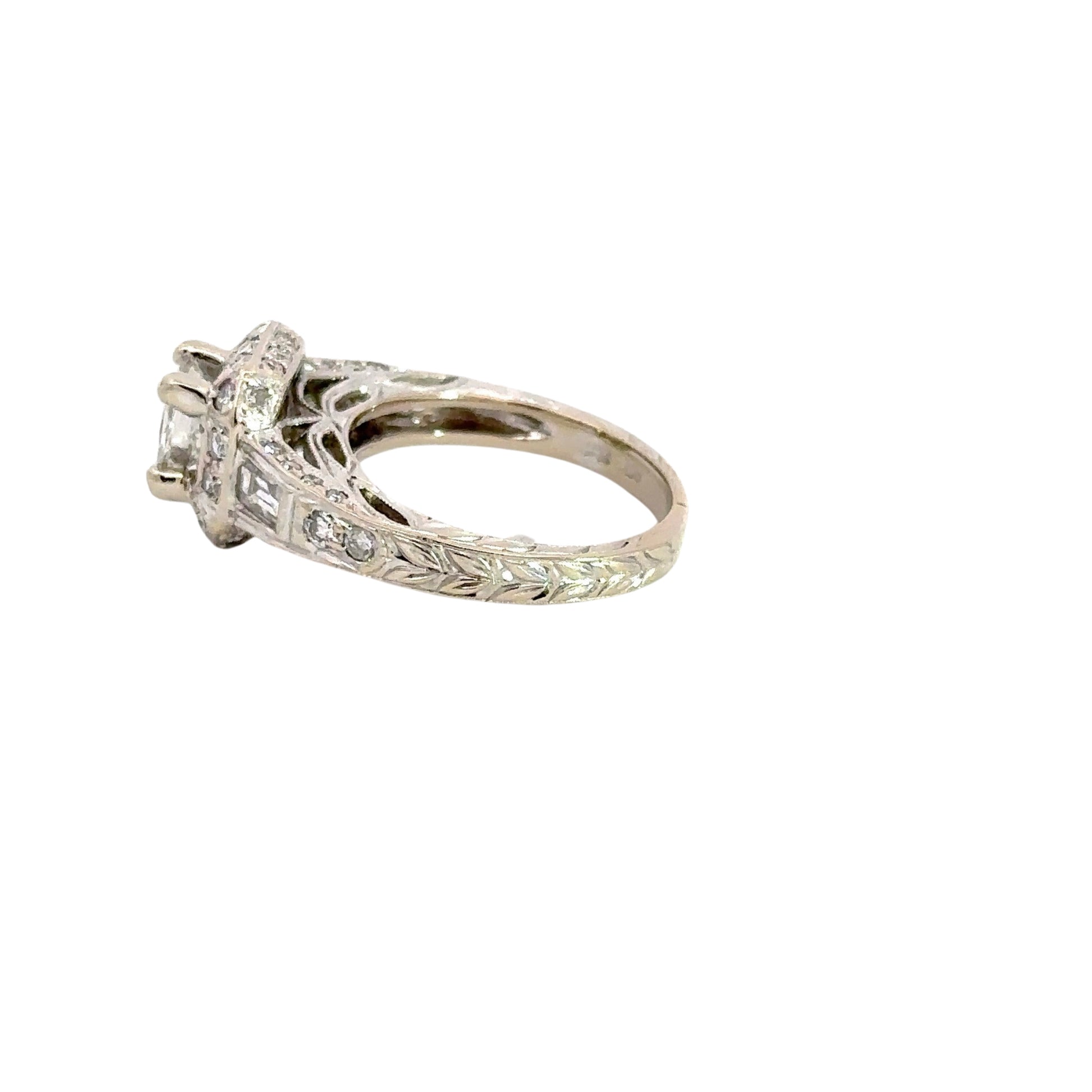 Side of ring with leaf=like engraving details on band. 1 Baguette diamond + 2 small round diamonds on side