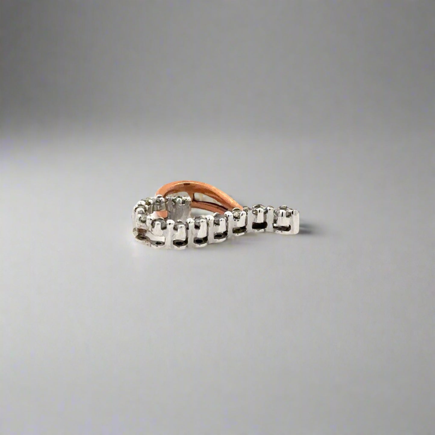 Side of pendant with scratches on white gold