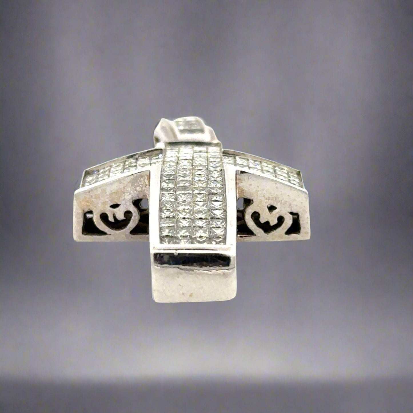 Bottom of white gold cross pendant with marks on the gold