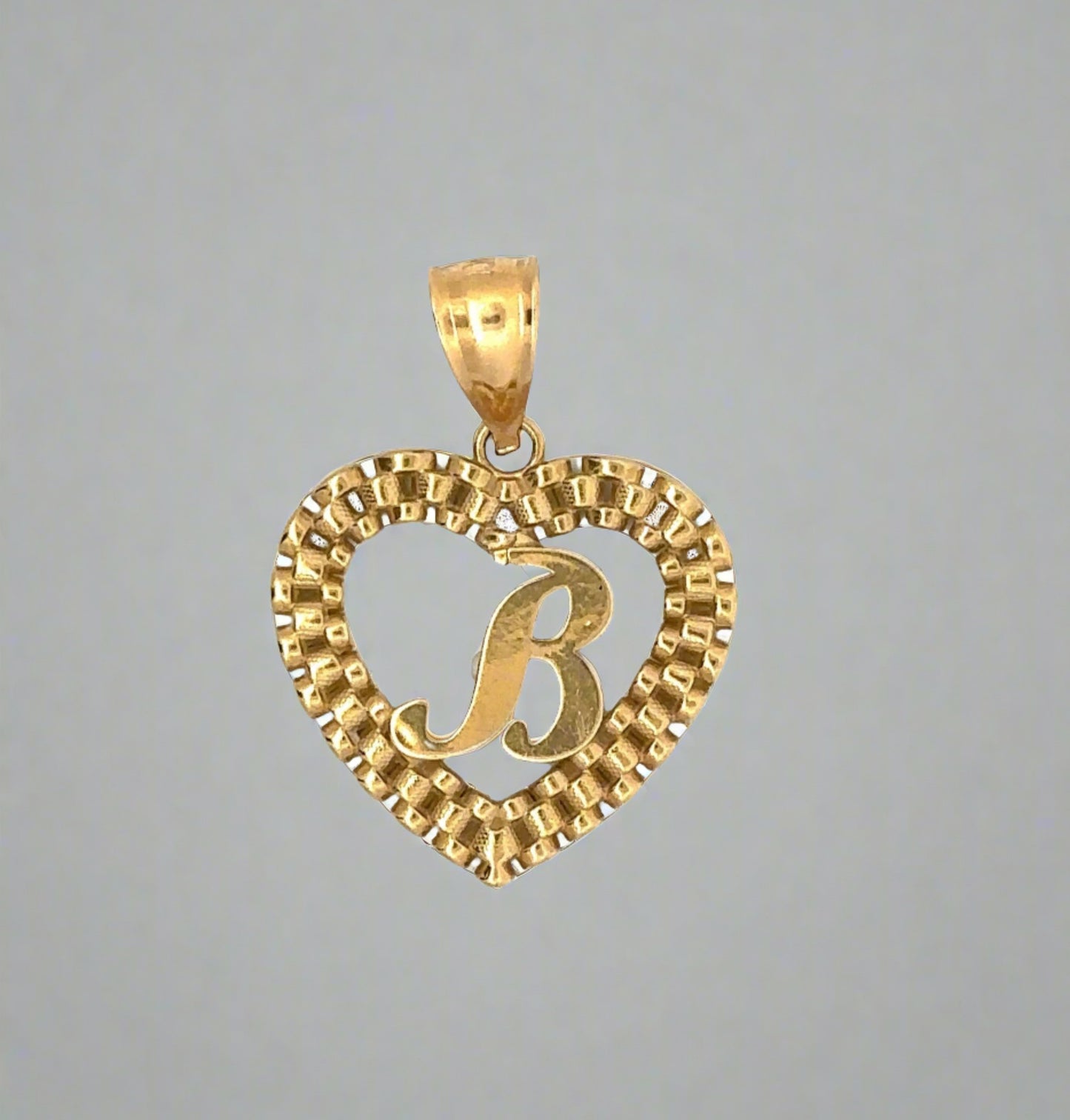 front of B heart rolex pendant in yellow gold with scratches on the B