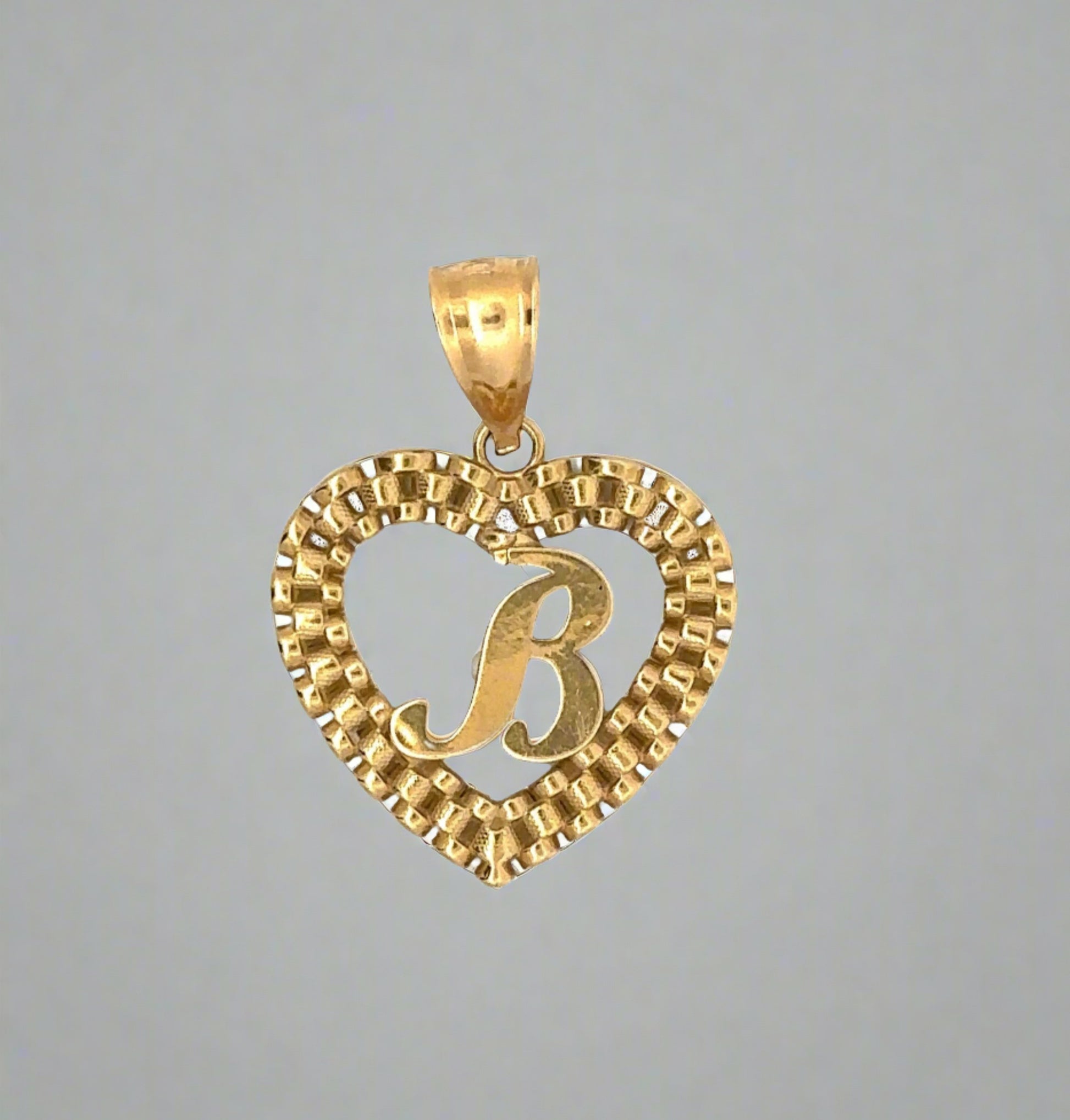 front of B heart rolex pendant in yellow gold with scratches on the B