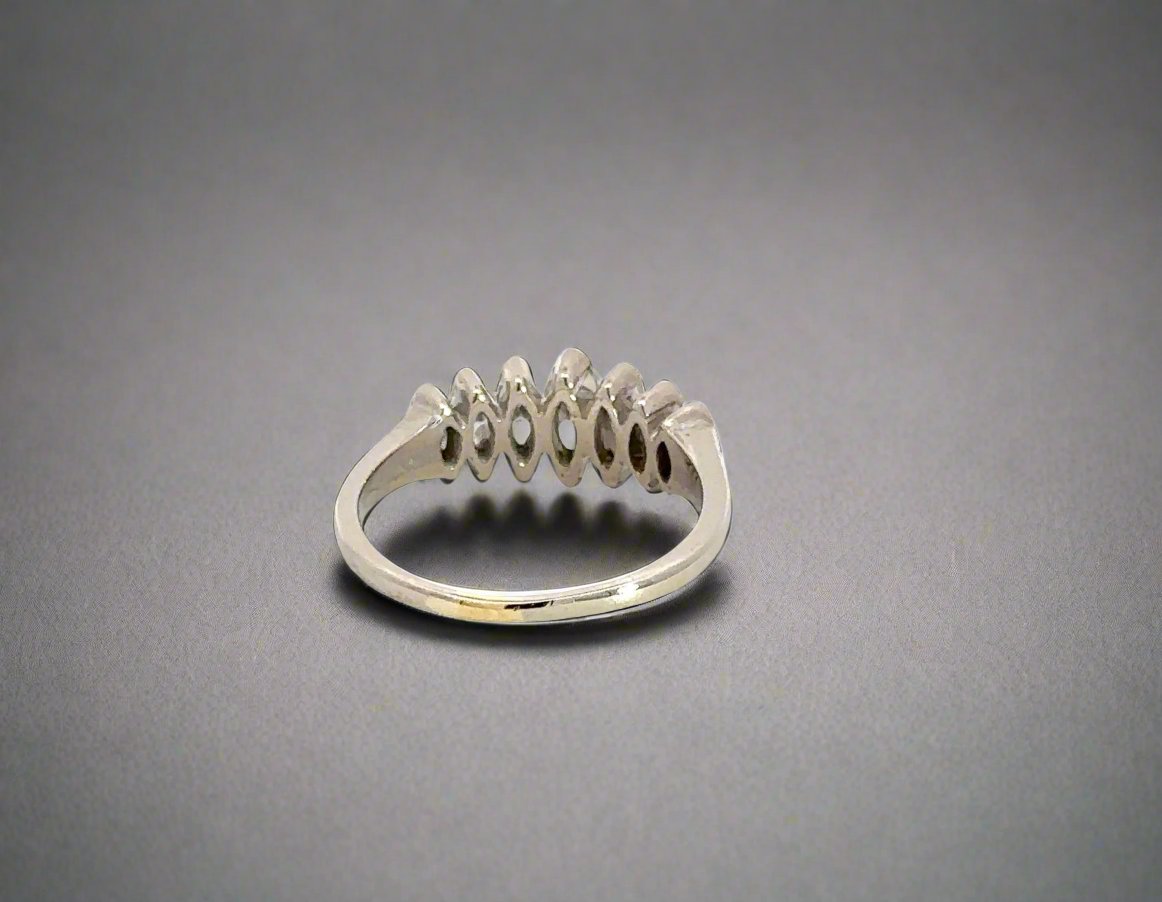 back of white gold diamond ring with scratches on gold
