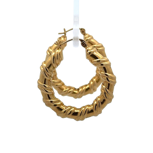 side view of yellow gold hoops with wrapped detailing