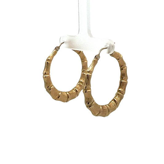 diagonal view of yellow gold bamboo hoops