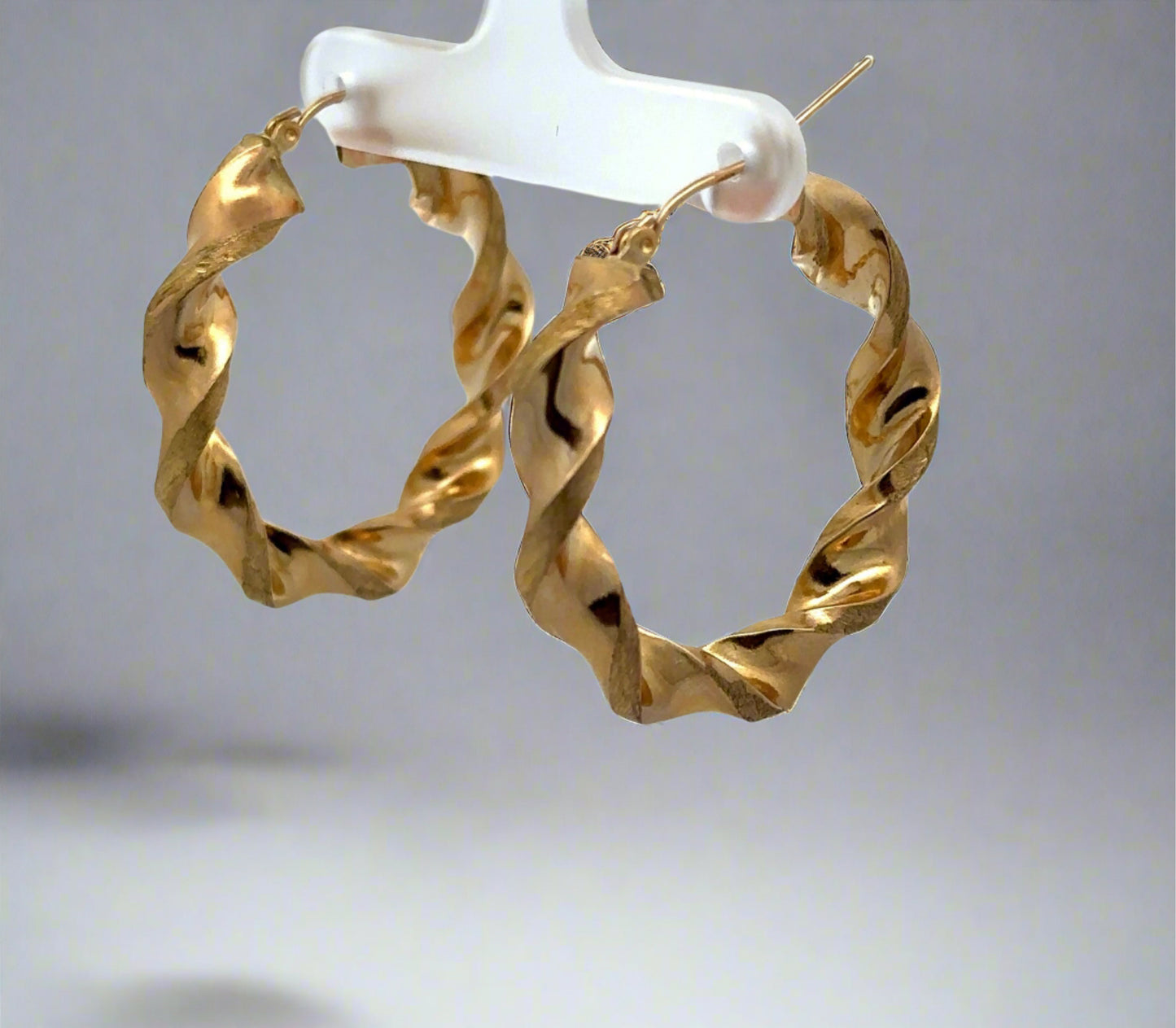 Diagonal view of yellow gold thick twist hoops