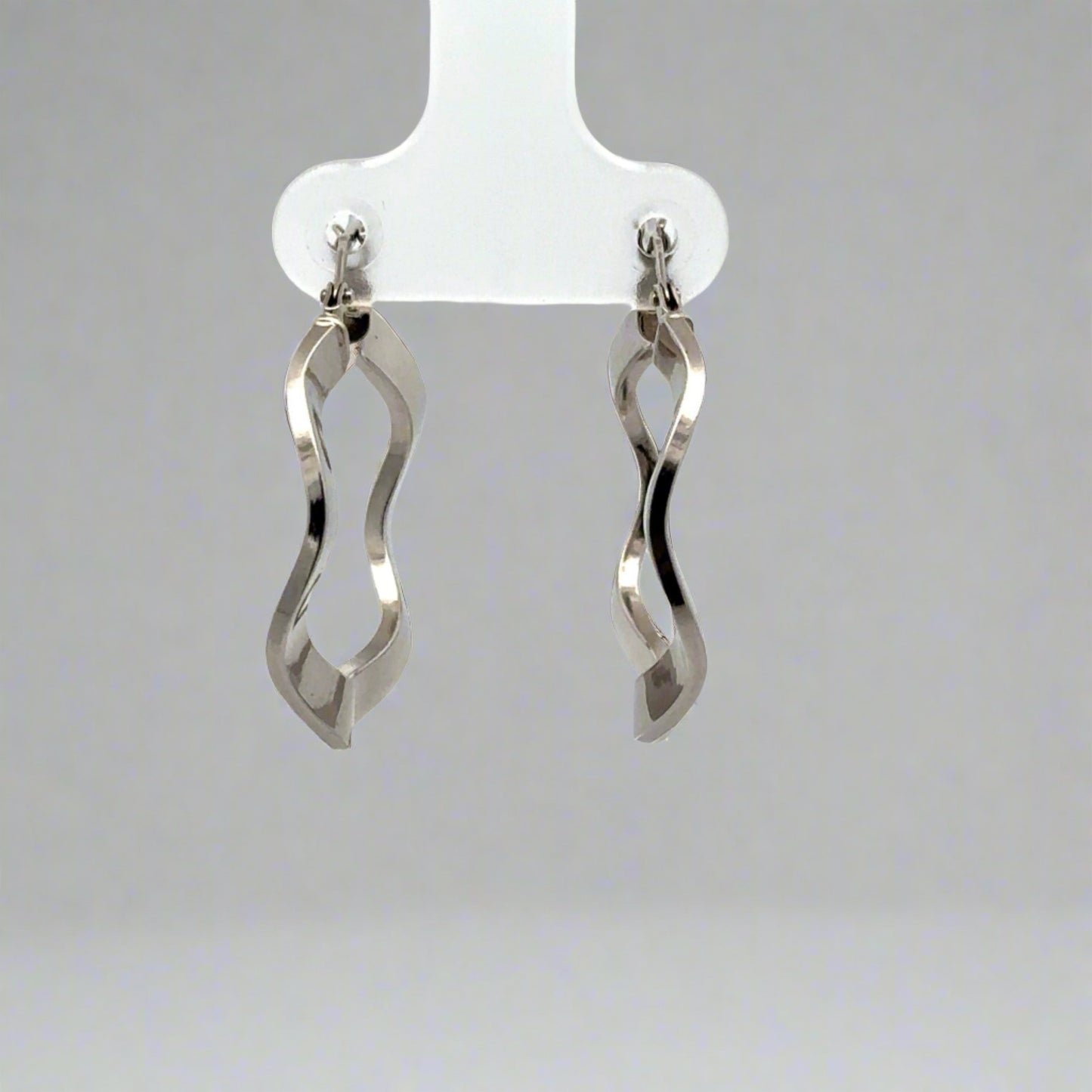 back of white gold wavy hoops
