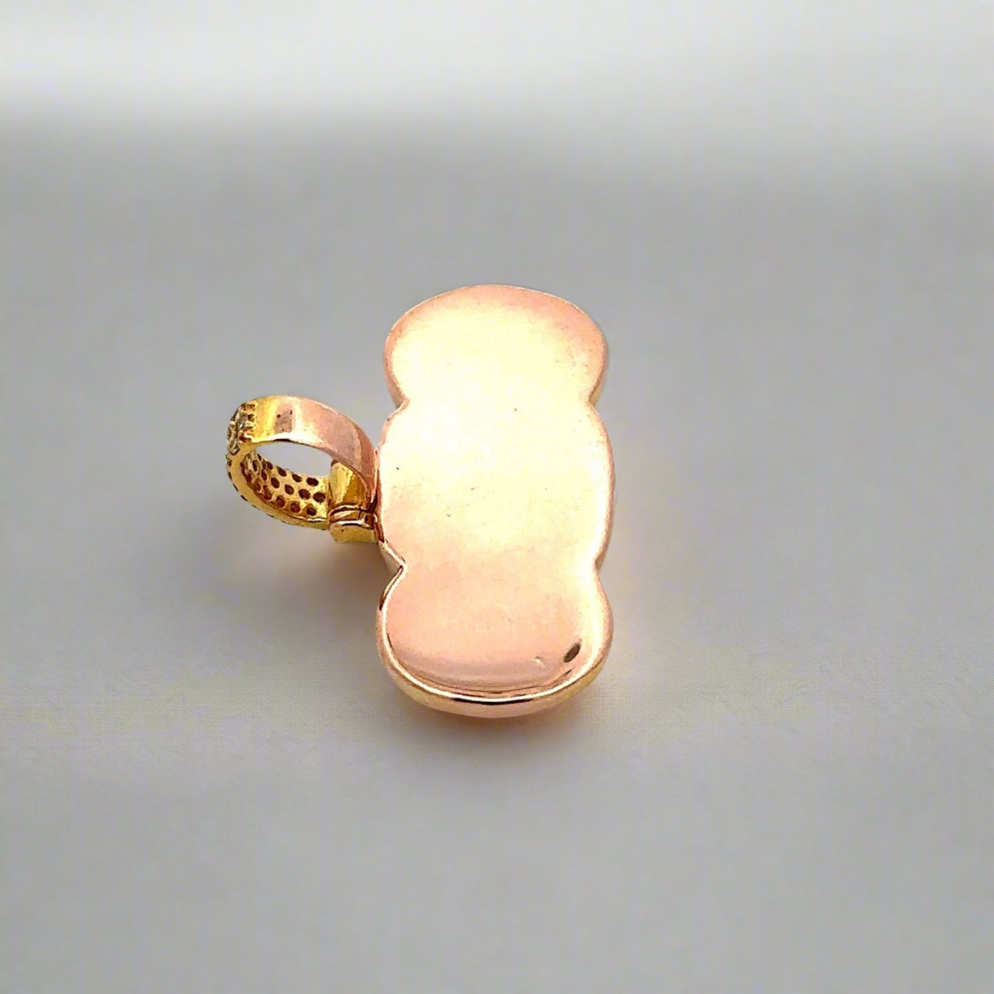 Back of yellow gold pendant with light scratches on back