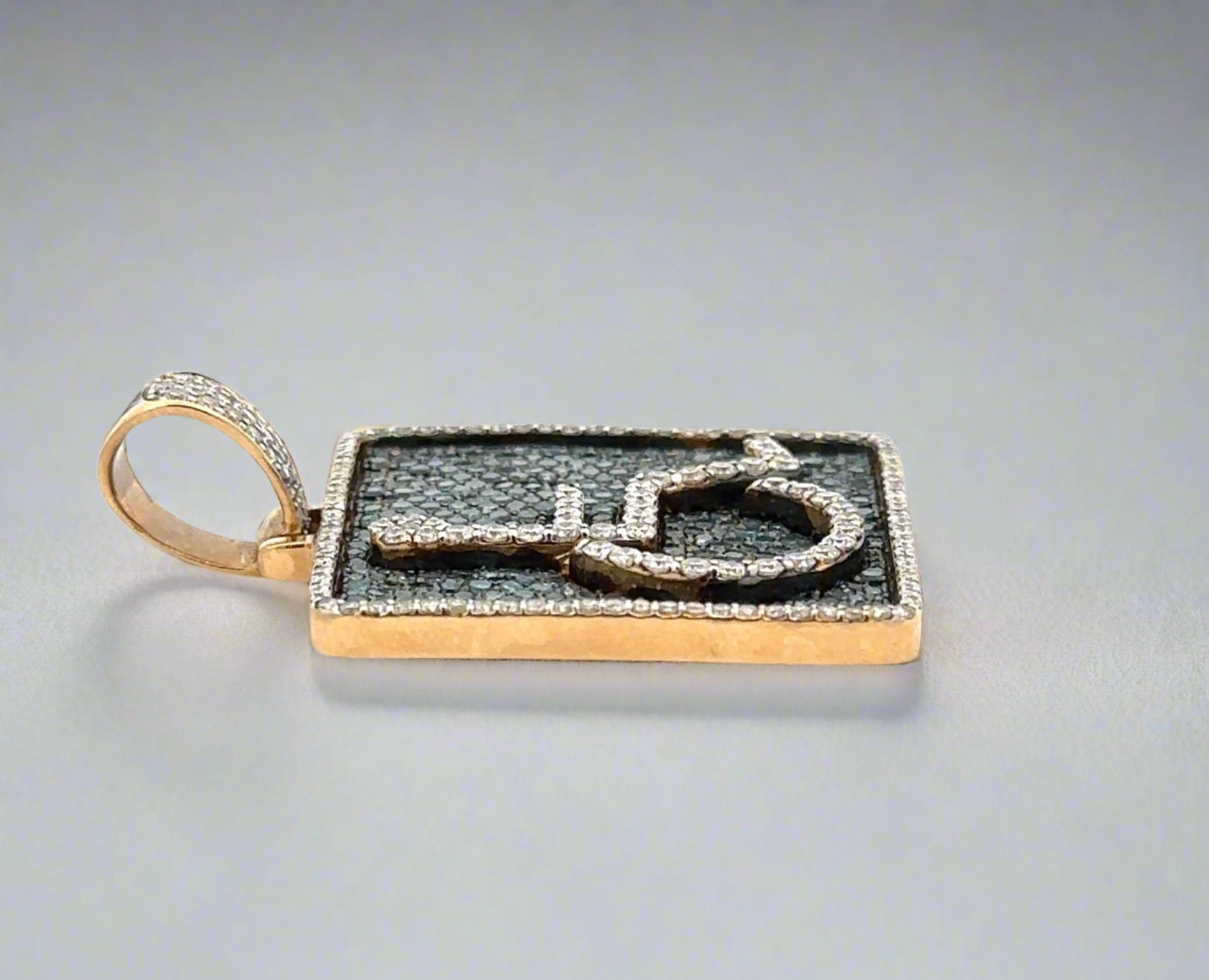 Side of pendant with yellow gold and round bail