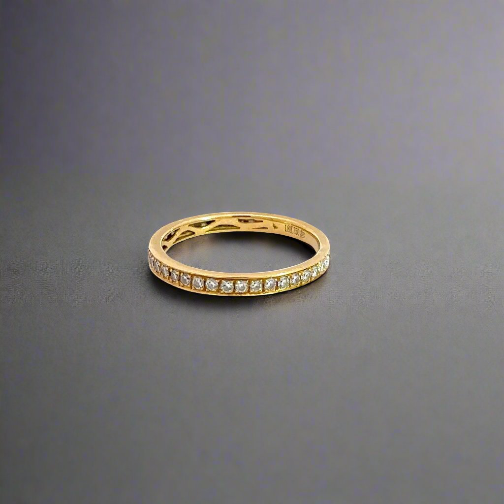 Side of yellow gold ring with small round diamonds. Shows 18K stamp on inside of band