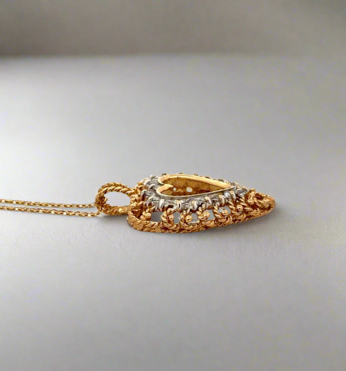 side of pendant with gold detailing