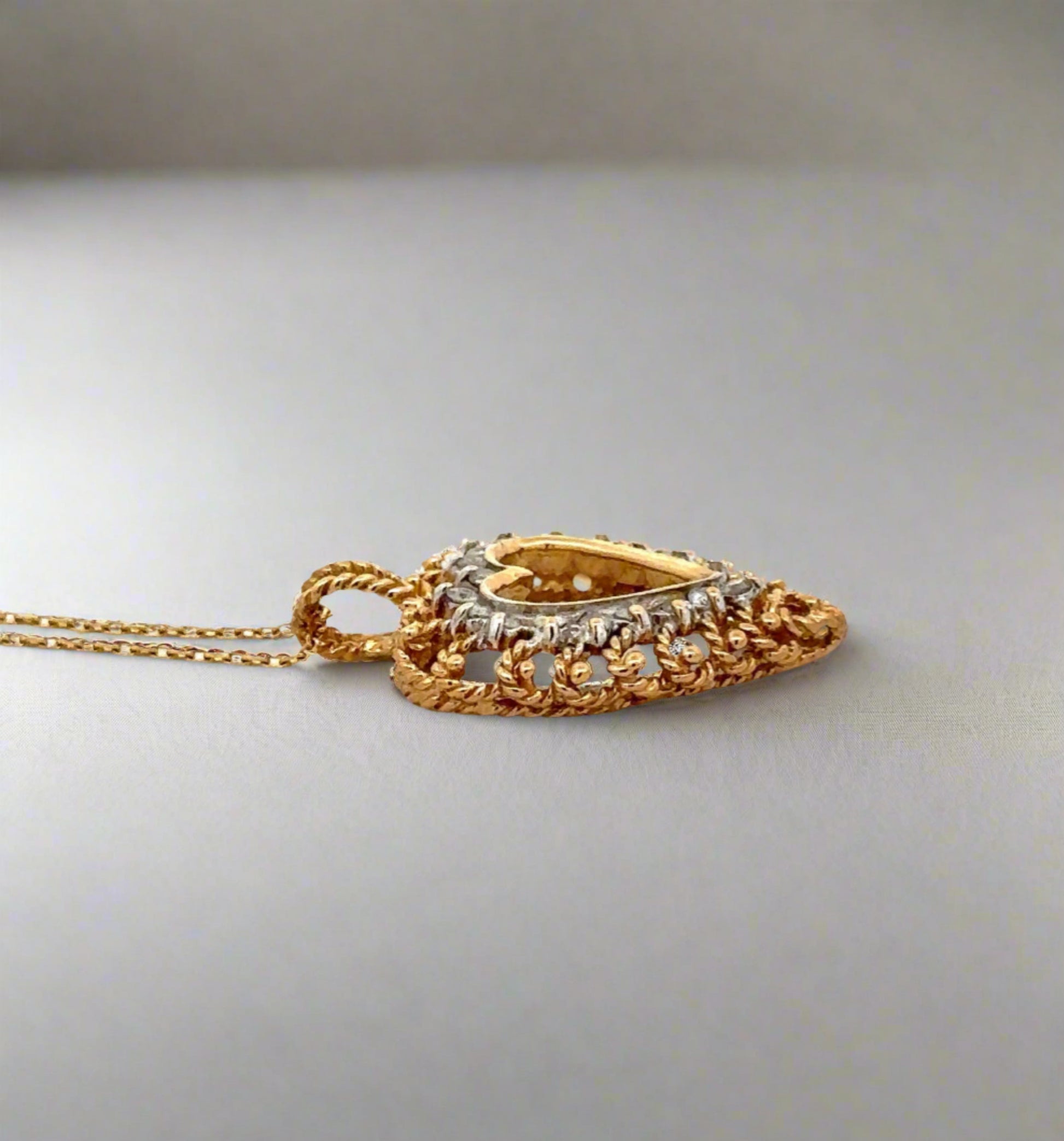 side of pendant with gold detailing