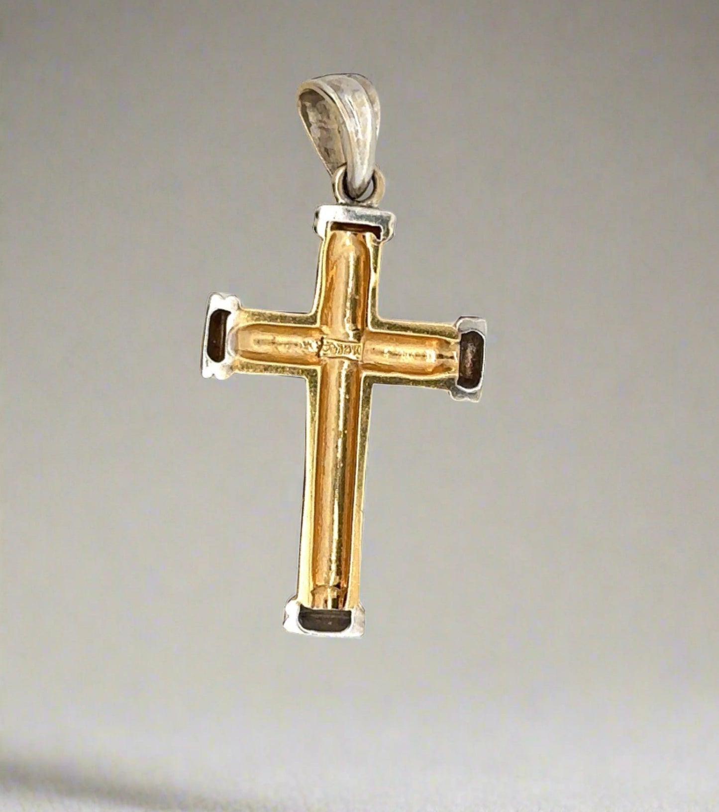 Back of yellow and white gold cross with hollow back, 14K stamp and scratches on gold
