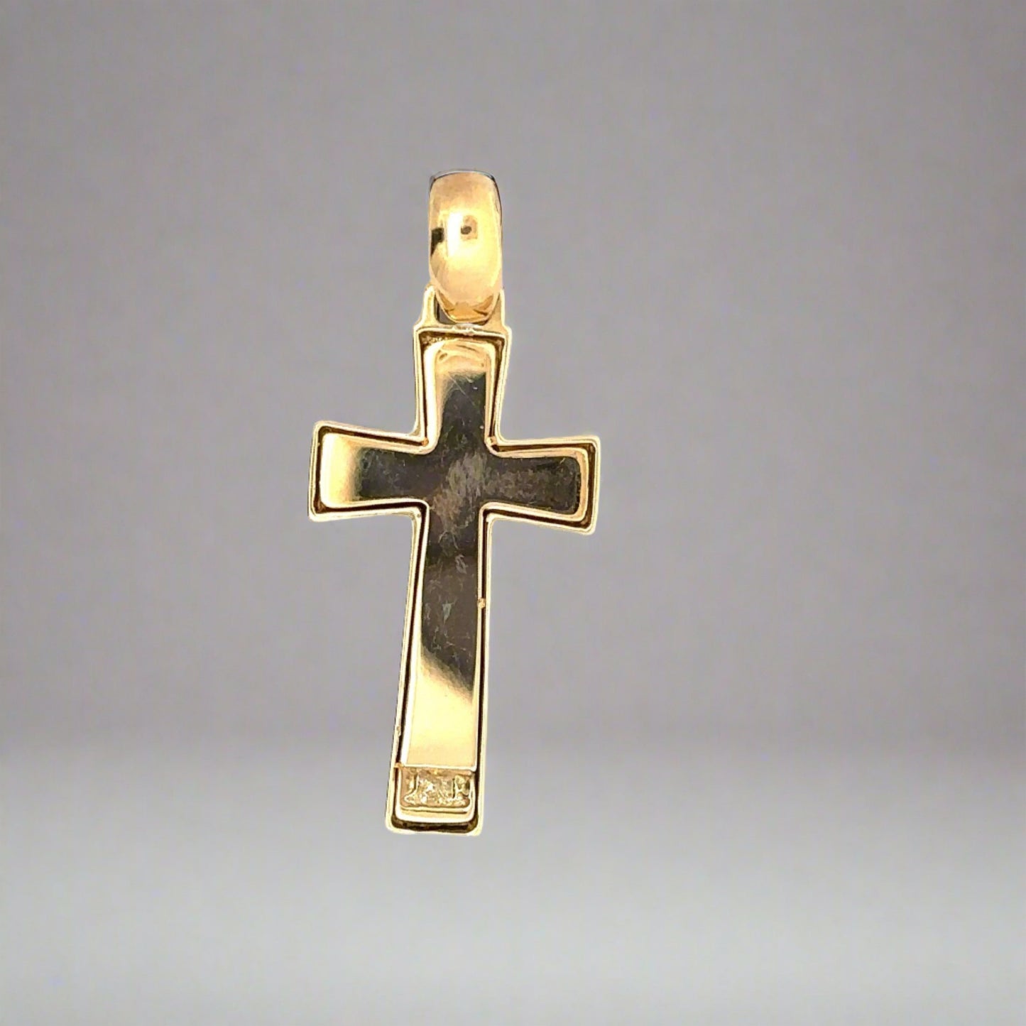 Back of yellow gold cross with scratches