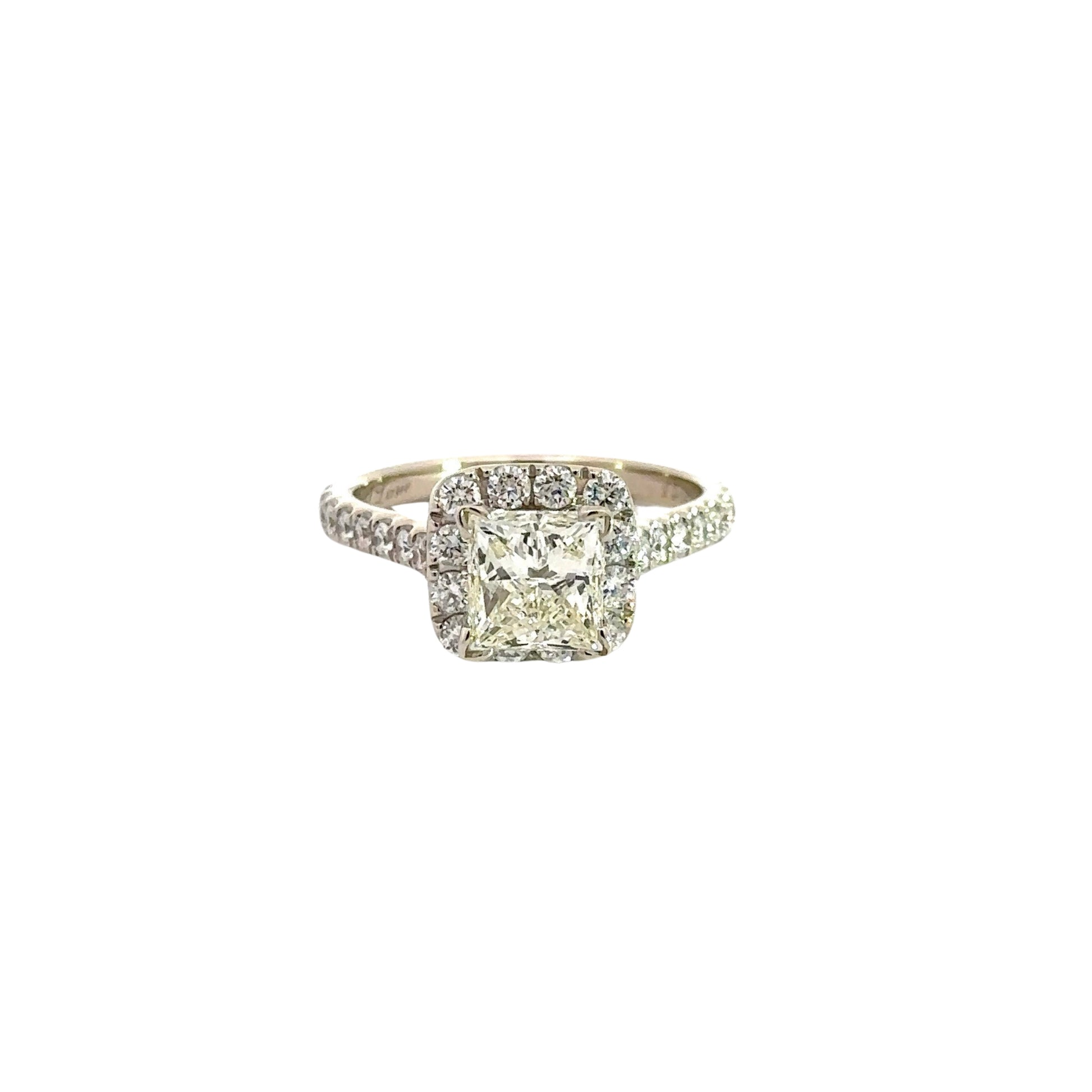Front of ring with 11 round diamonds around 1.5 carat princess-cut diamond and diamonds on side of band.