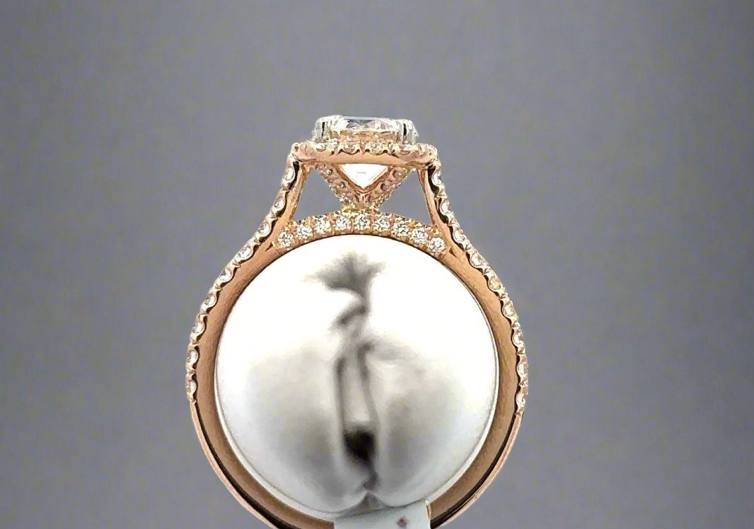 Aerial view of ring with 9 small round diamonds on top of the band and 4 small roudn diamonds on hidden halo