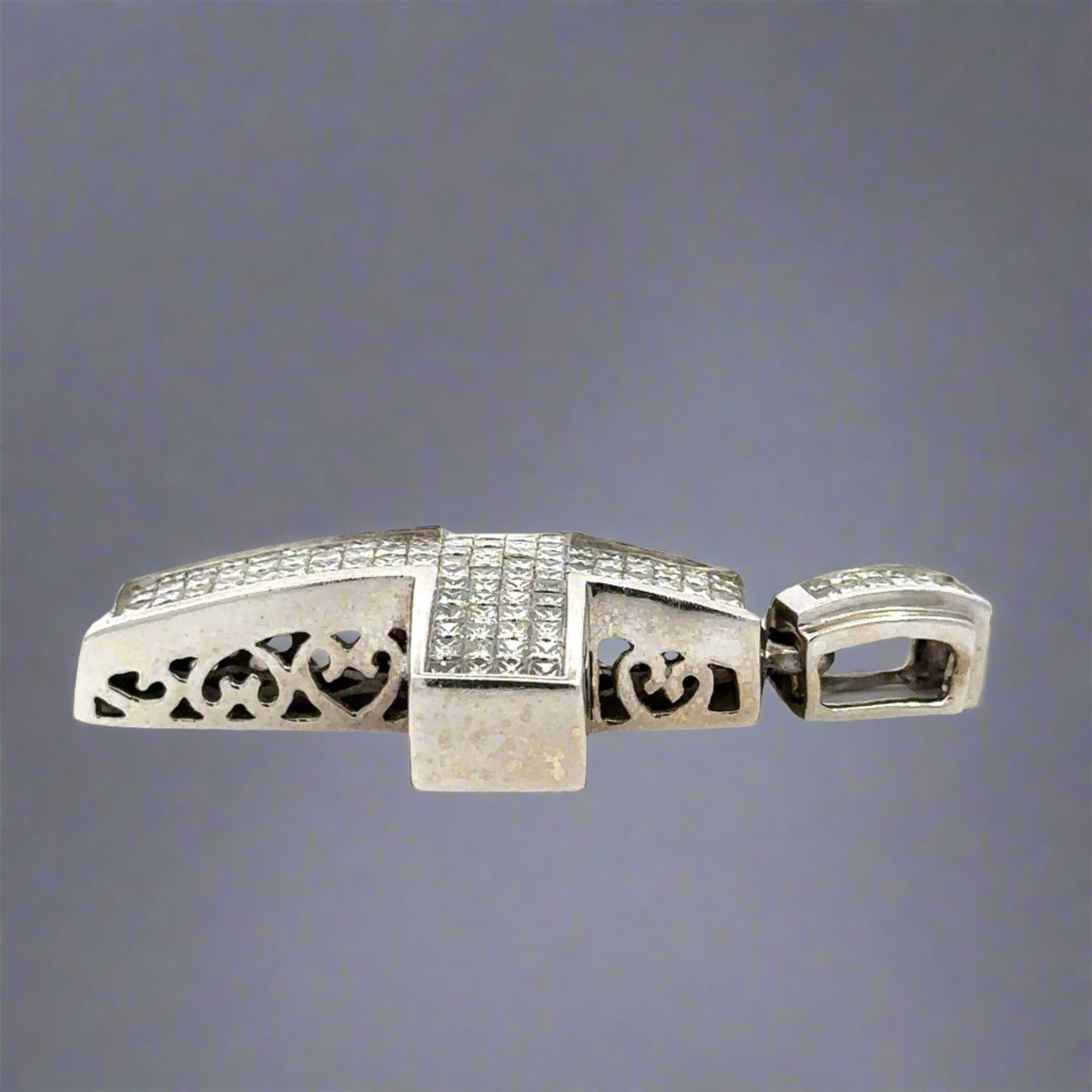 Side of diamond cross pendant with heart outlines on the side