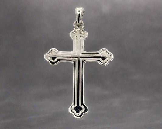 Front of white gold cross with detail lines tracing the inside. Small scratches on gold.