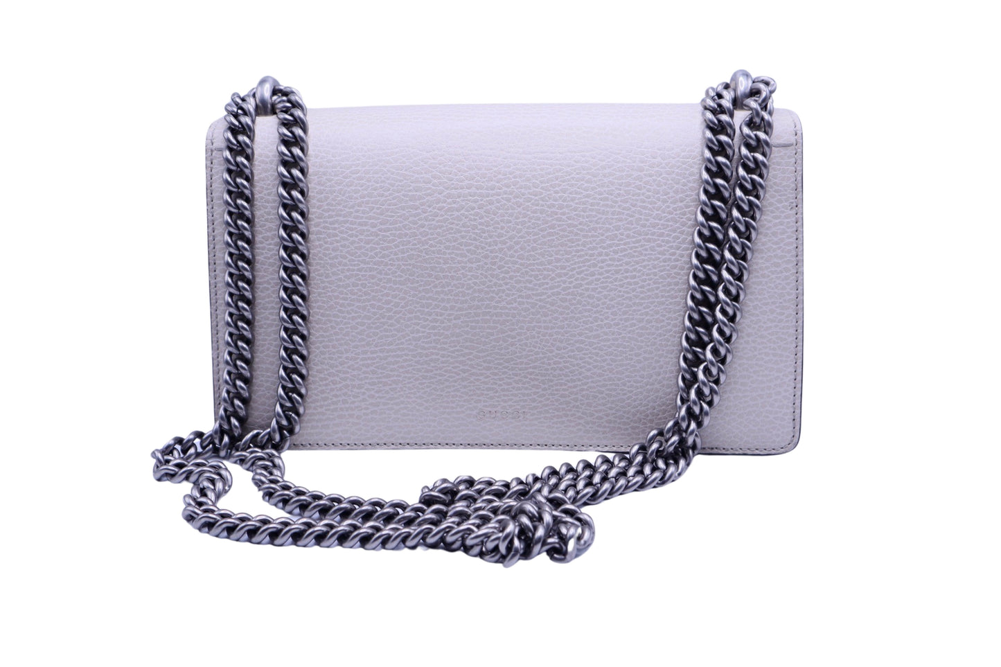 Back of white textured leather bag with silver adjustable chain