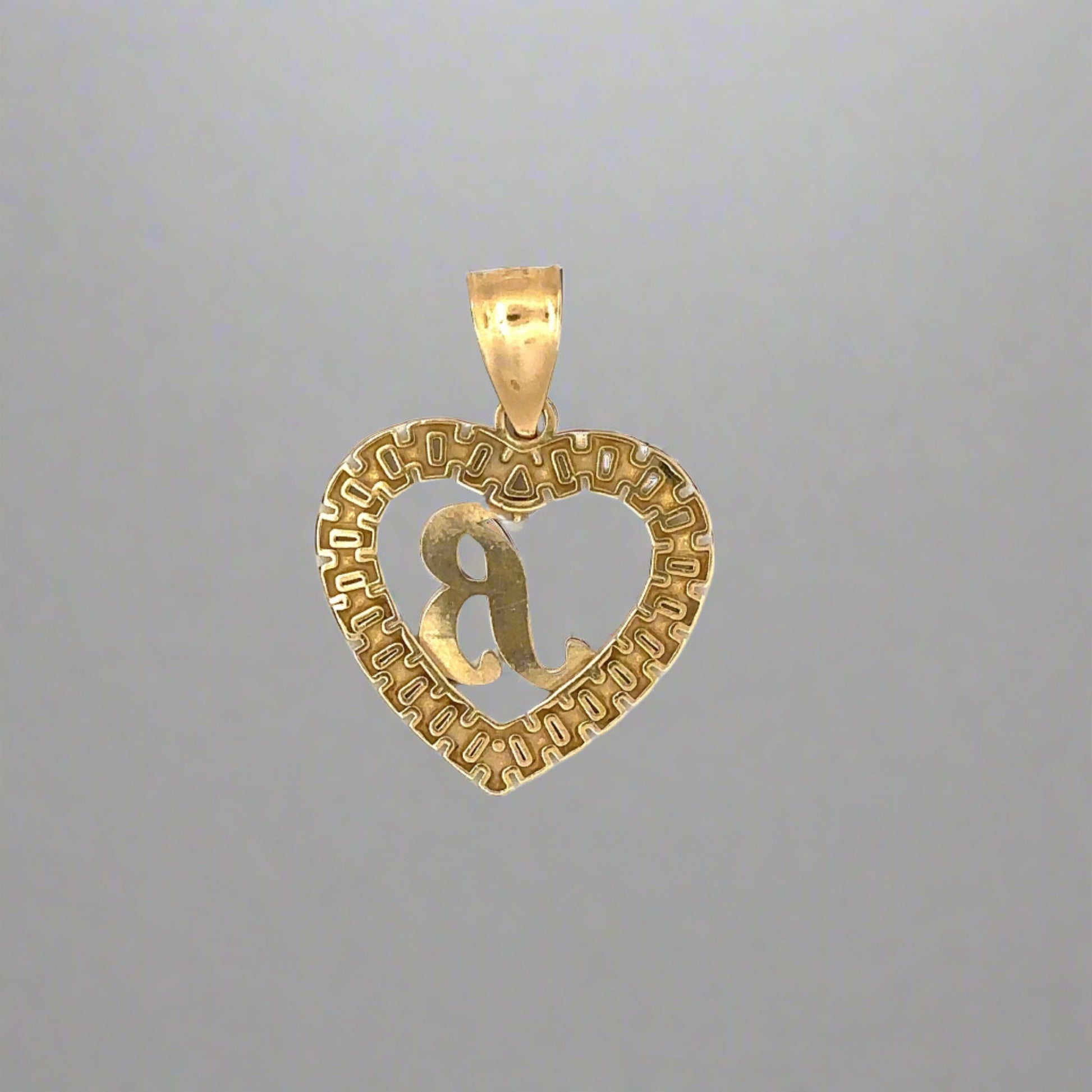 Back of yellow gold B heart pendant with scratches on the gold