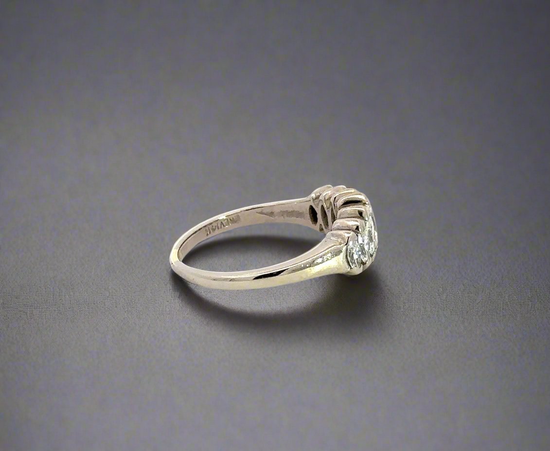 side of white gold diamond ring with scratches on gold