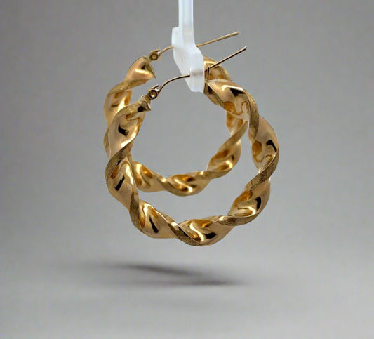 side of yellow gold twist hoops