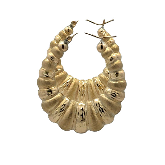 side of scalloped and brushed yellow gold hoops