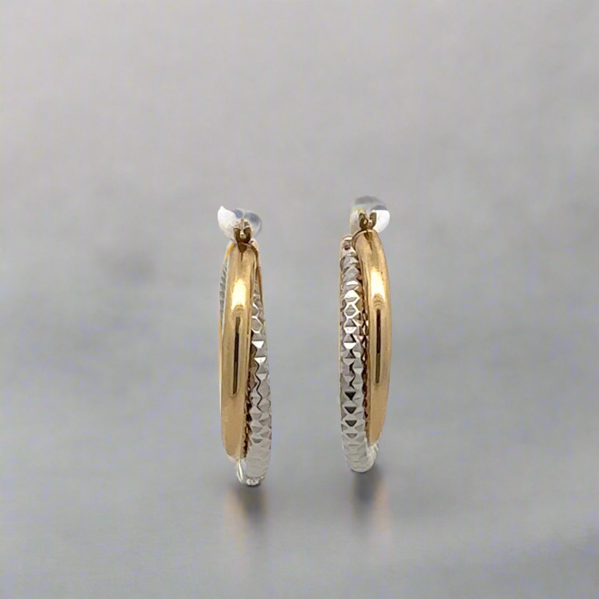 Front of two-toned hoop earrings