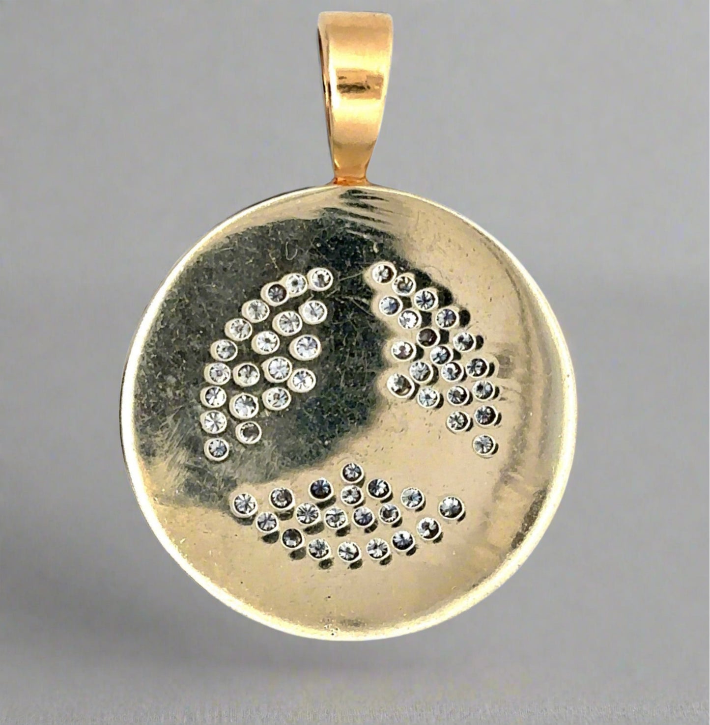 Back of pendant showing scratches on gold