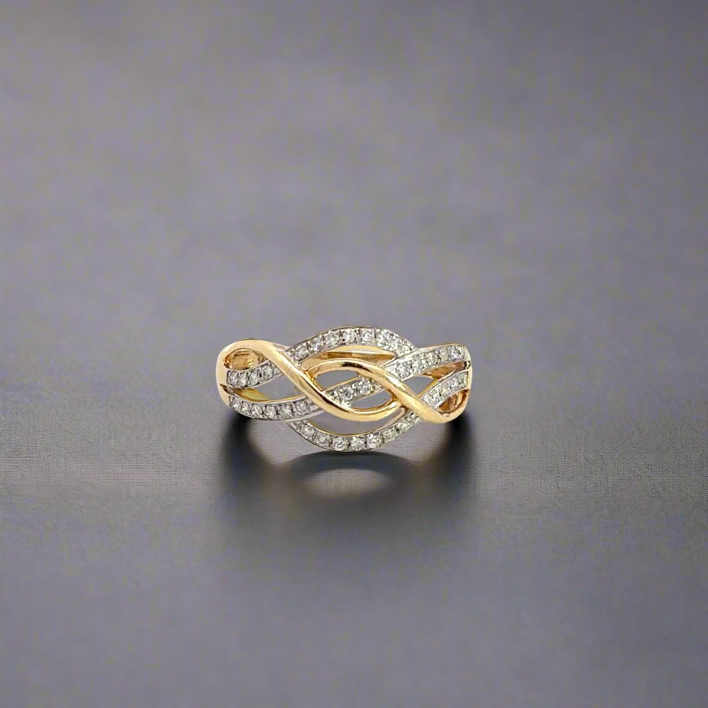 Front of yellow gold crossover ring with round diamonds on part of the crossover design.