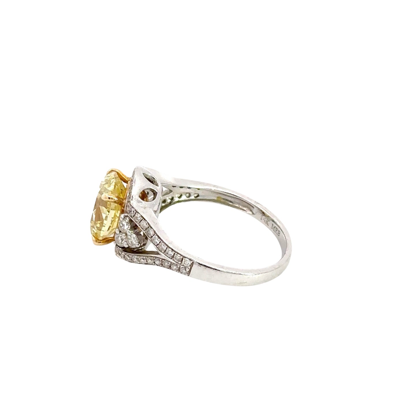 side of white gold ring with yellow oval diamond with small round diamonds around it
