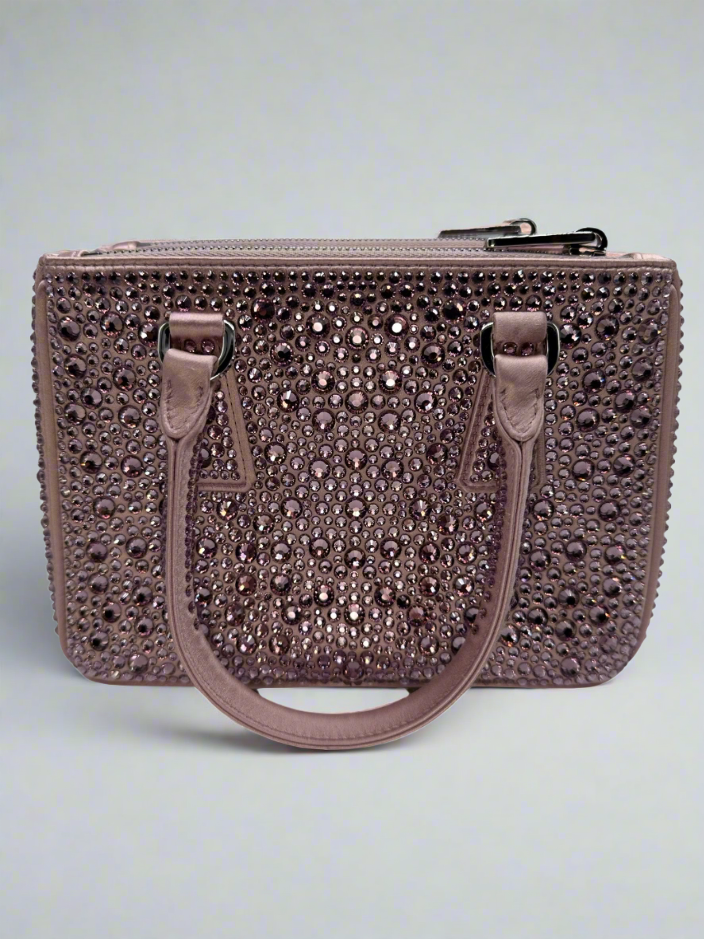 Pictured: The back of the Prada Galleria Crystal mini satin bag in pink covered with pink crystals. No imperfections.