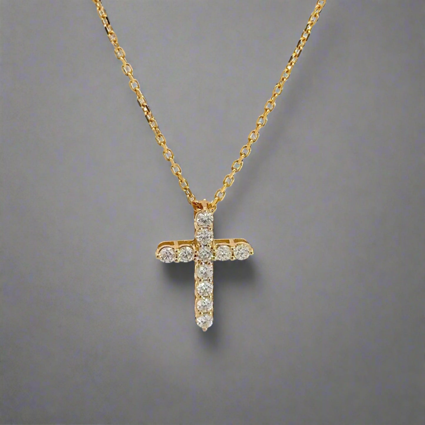 Front of yellow gold diamond cross with 11 round natural diamonds